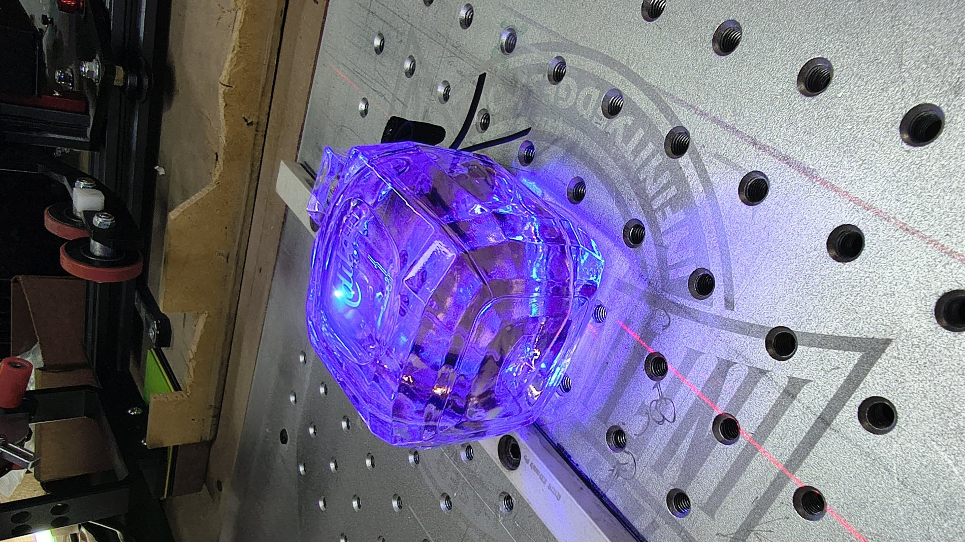 Engraved acrylic panel lit from the edge on a workshop pegboard