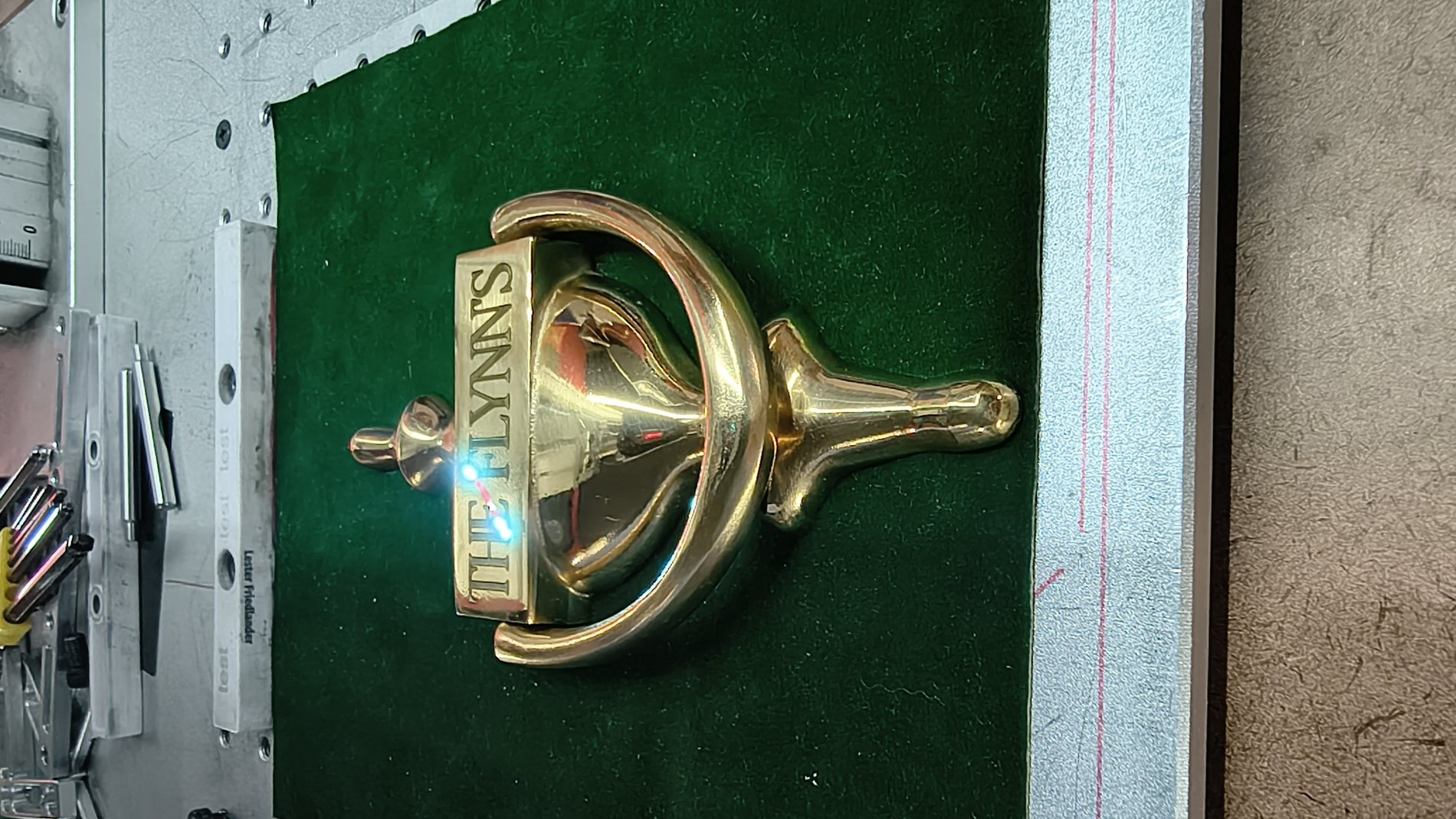 Polished brass trophy component engraved with custom detailing