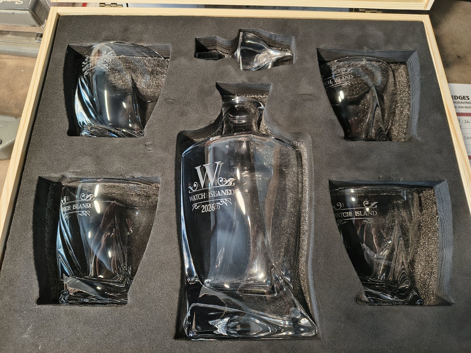 Set of etched glassware presented in a fitted display case
