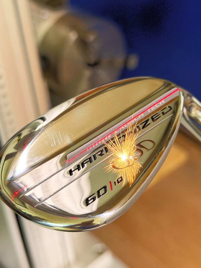 Golf wedge with a custom engraved club head