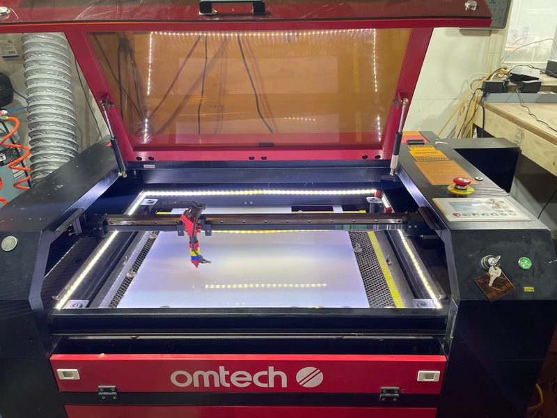Open bed of the OMTech CO2 laser mid-job