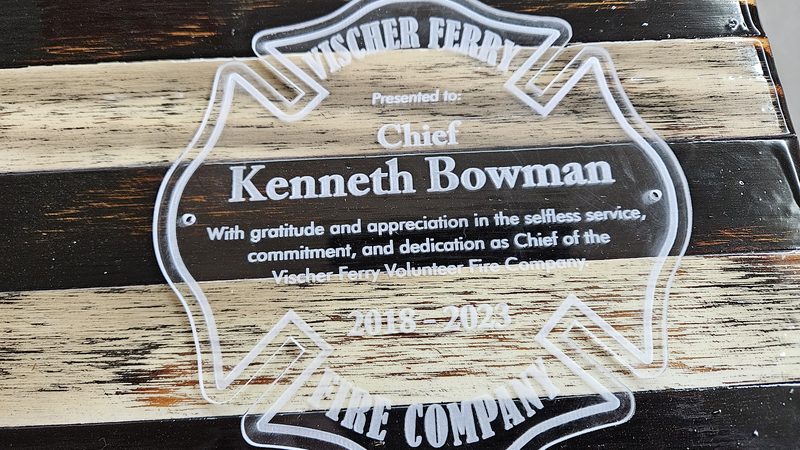Maltese cross plaque engraved in recognition of a volunteer fire chief
